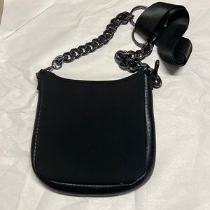 Haute shore neoprene cross body with fun metallic strap.